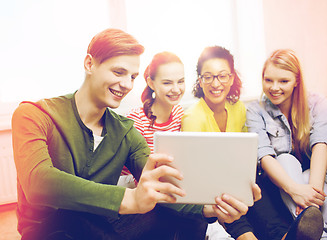 Image showing smiling students making picture with tablet pc