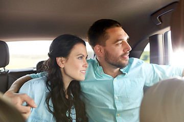 Image showing happy man and woman hugging in car