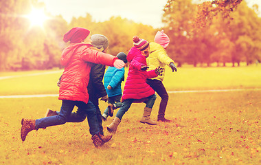 Image showing group of happy little kids running outdoors