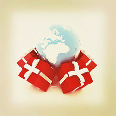 Image showing Traditional Christmas gifts and earth. Global holiday concept . 