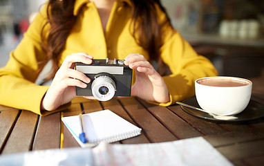 Image showing close up of woman with camera at city cafe