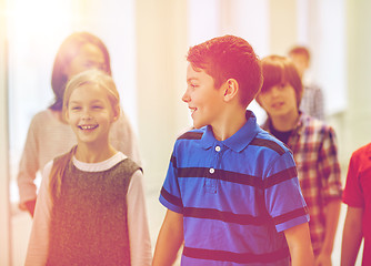 Image showing group of smiling school kids walking in corridor