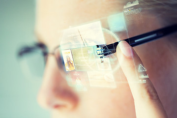 Image showing close up of woman in glasses with virtual screen