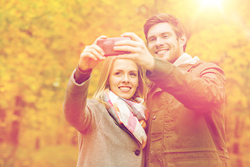 Image showing smiling couple hugging in autumn park