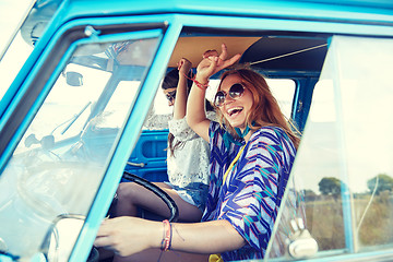 Image showing smiling young hippie women driving minivan car