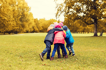 Image showing group of happy children hugging in autumn park