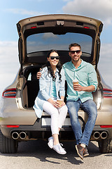 Image showing happy couple with coffee at hatchback car trunk