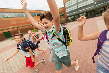 Image showing group of happy elementary school students running