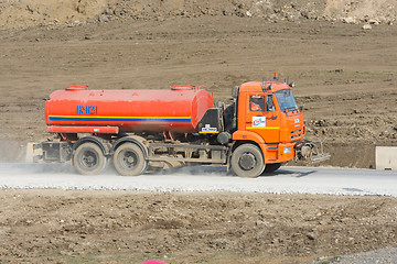 Image showing Taman, Russia - March 8, 2016: Tanker traveling on a dirt road from the gravel. Taman, Russia