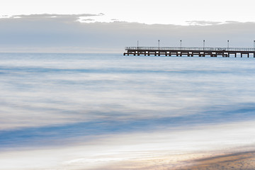 Image showing The seashore overlooking the marina after sunset, photographed with a long exposure