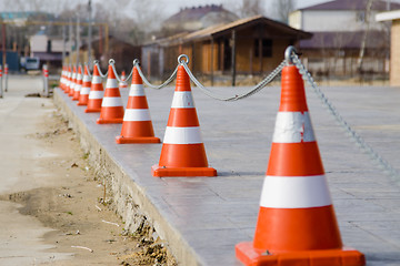 Image showing Fencing the territory of the plastic cones connected by a chain