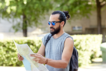 Image showing man traveling with backpack and map in city