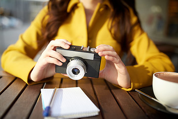 Image showing close up of woman with camera at city cafe