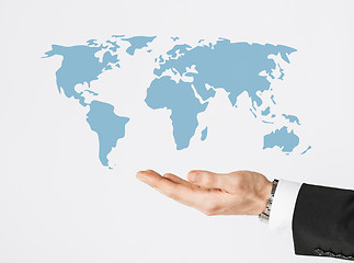 Image showing close up of businessman hand showing world map