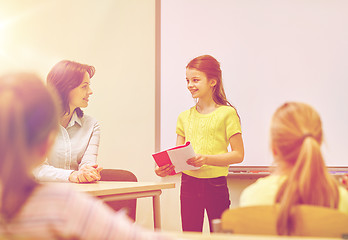 Image showing group of school kids with teacher in classroom