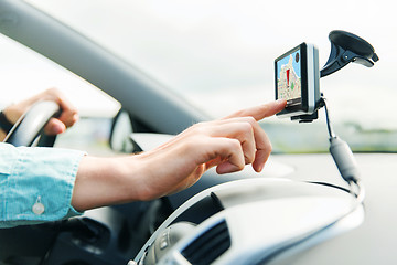 Image showing close up of man with gps navigator driving car