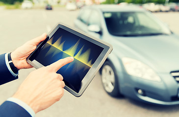 Image showing close up of hands with diagram tablet pc and car