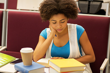 Image showing student girl with books and coffee on lecture