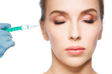 Image showing woman face and hand with syringe making injection