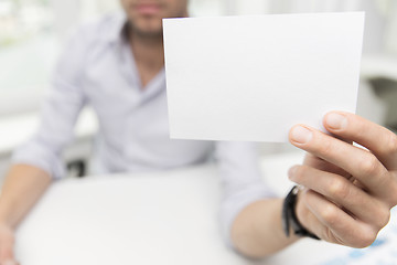 Image showing close up of businessman with blank paper at office