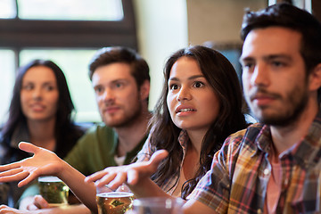 Image showing friends with beer watching football at bar or pub