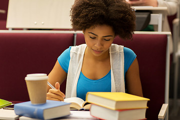 Image showing student girl with books and coffee on lecture