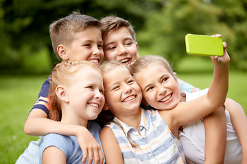 Image showing happy kids or friends taking selfie in summer park