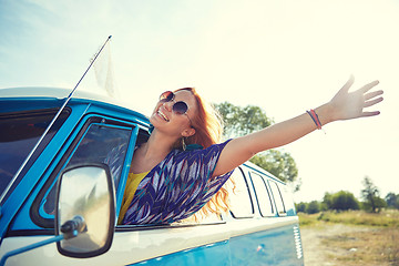 Image showing smiling young hippie woman driving minivan car