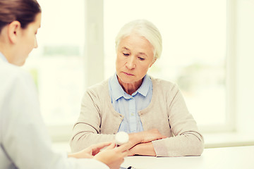 Image showing doctor with medicine and senior woman at hospital