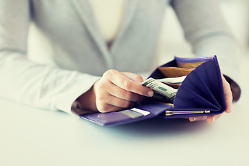 Image showing close up of woman hands with wallet and money