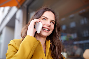 Image showing smiling young woman or girl calling on smartphone