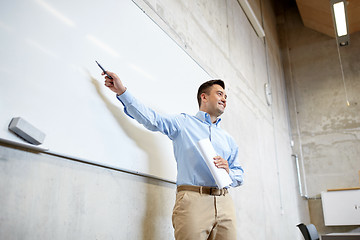 Image showing teacher pointing marker to white board at lecture