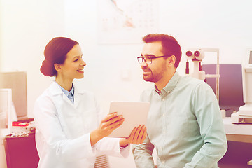 Image showing optician with tablet pc and patient at eye clinic