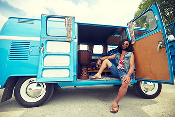 Image showing smiling young hippie man in minivan car