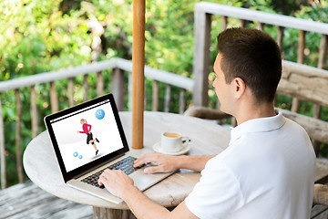 Image showing man with fitness app on laptop screen