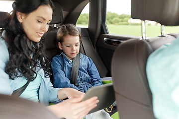 Image showing happy family with tablet pc driving in car