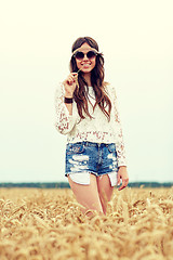 Image showing smiling young hippie woman on cereal field