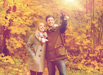 Image showing smiling couple hugging in autumn park