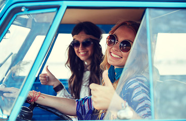 Image showing smiling young hippie women driving minivan car