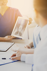 Image showing close up of happy doctors with x-ray at hospital