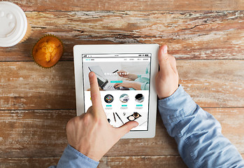 Image showing close up of hands with online shop on tablet pc