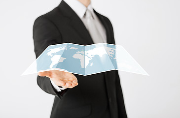 Image showing close up of businessman showing world map