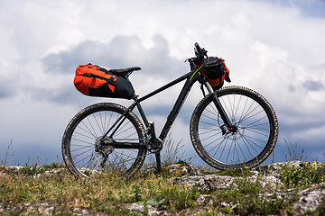 Image showing Bicycle with orange bags for travel