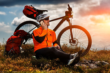 Image showing Sportive Man Stops Cycling and Has a Rest on Valley