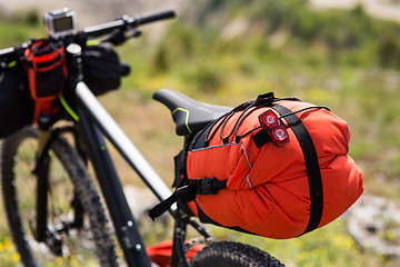 Image showing Bicycle with orange bags for travel
