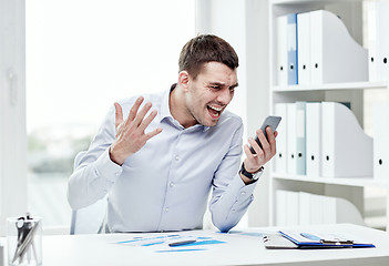 Image showing close up of businessman with smartphone