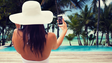 Image showing woman taking selfie with smartphone on beach