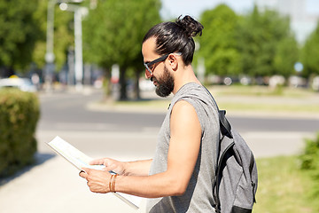 Image showing man traveling with backpack and map in city