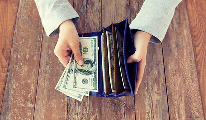 Image showing close up of woman hands with wallet and money