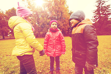 Image showing group of happy children talking in autumn park